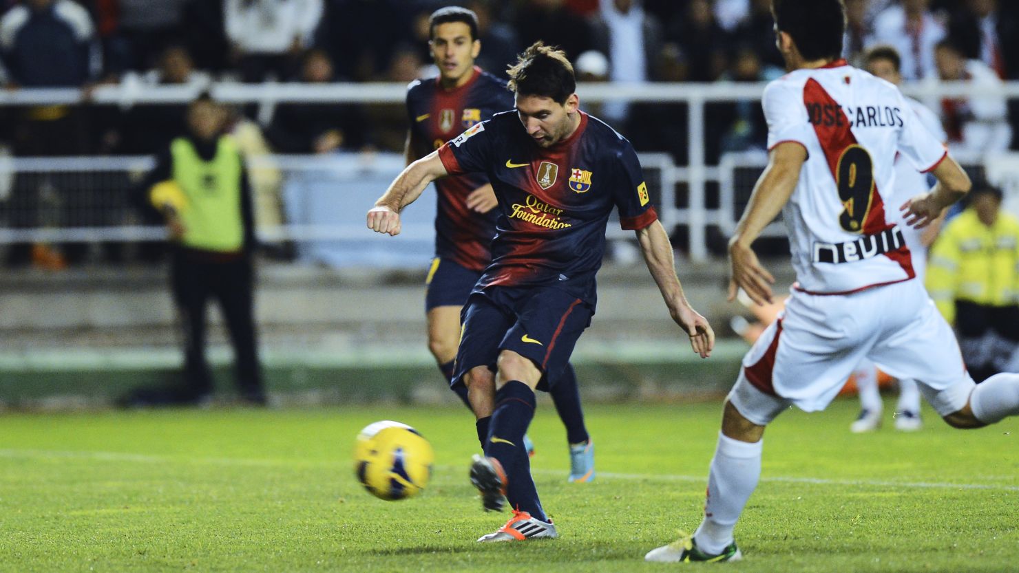 Barcelona star Lionel Messi scores his first goal during the 5-0 victory at Rayo Vallecano on Saturday.