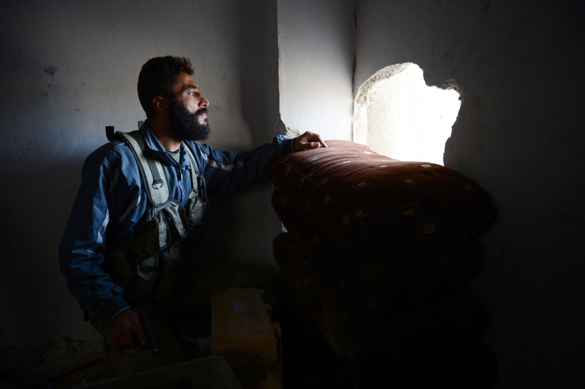 Commander Abu Sleiman looks at the pro-Syrian government forces' position prior to an attack in Aleppo on Saturday, October 27.  The latest reports of violence saw each side accuse the other of violating the conditions of a cease-fire called over religious holiday Eid al-Adha.