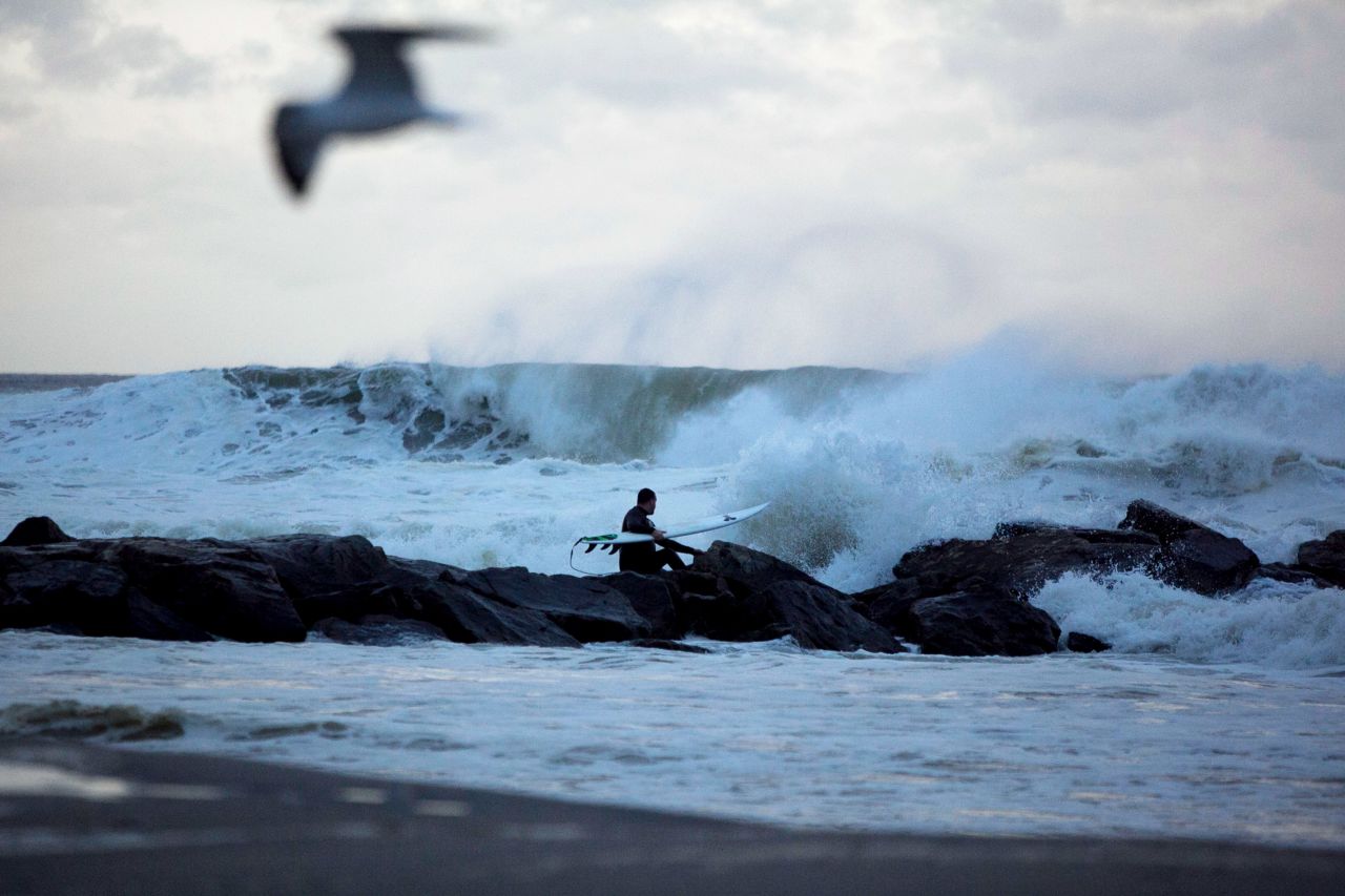 A man surfs at Rockaway Beach in Queens as Hurricane Sandy approaches Sunday.