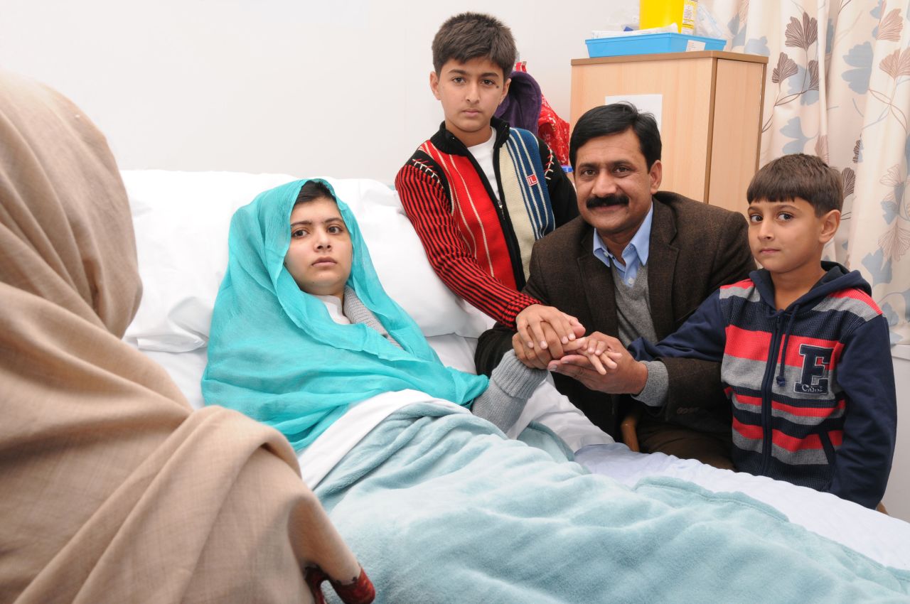 Malala sits up in her hospital bed with her father, Ziauddin, and her two younger brothers, Atal Khan, right, and Khushal Khan on Friday, October 26, 2012, at the Queen Elizabeth Hospital Birmingham in Birmingham, England.