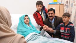 BIRMINGHAM, ENGLAND - OCTOBER 26: (EDITORIAL USE ONLY) In this handout photo provided by the Queen Elizabeth Hospital Birmingham, Malala Yousafzai sits up in her hospital bed with her father Ziauddin and her two younger brothers, Atal Khan (R) and Khushal Khan (C), on October 26, 2012 in Birmingham, United Kingdom. 15 year-old Malala is being treated in the UK after she was shot by the Taliban in Pakistan two weeks ago. (Photo by Queen Elizabeth Hospital Birmingham via Getty Images)