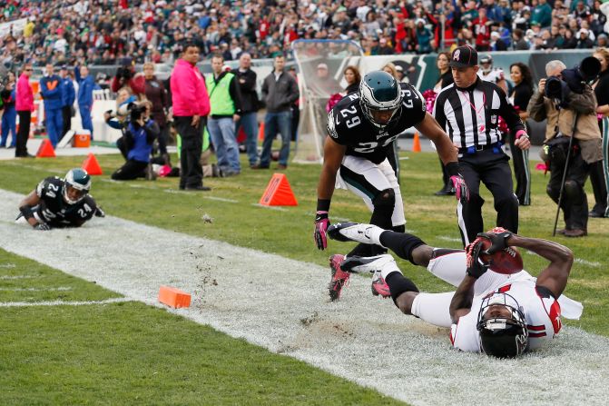 No. 24 Nnamdi Asomugha and No. 29 Nate Allen of the Philadelphia Eagles look on as Atlanta Falcons' wide receiver Julio Jones scores a touchdown during the second quarter Sunday in Philadelphia.