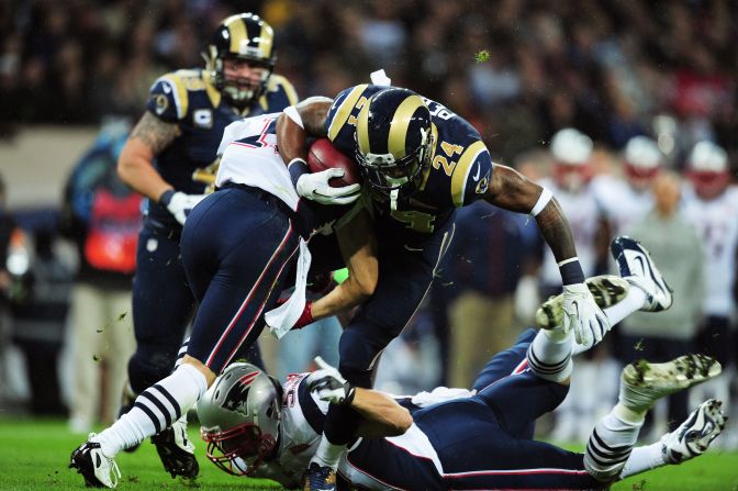 New England's No. 11 Julian Edelman and No. 53 Jeff Tarpinian tackle St. Louis' Isaiah Pead on Sunday.