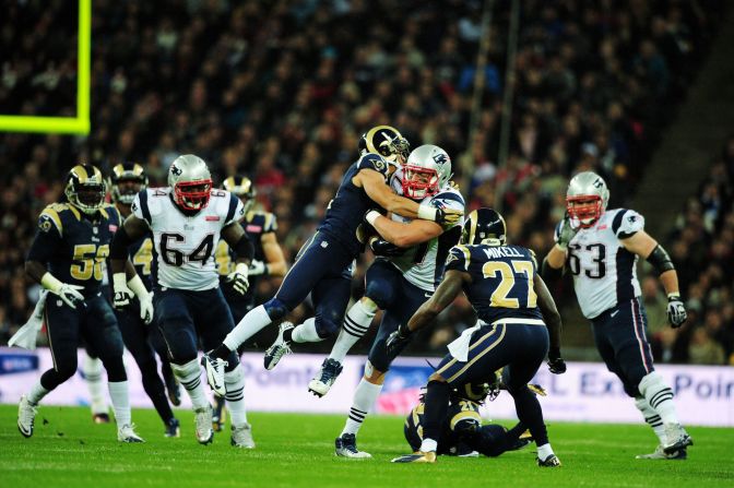 Cortland Finnegan of the St. Louis Rams tackles Rob Gronkowski of the New England Patriots<br />during Sunday's game at Wembley Stadium in London.