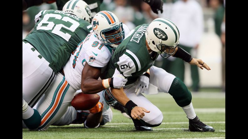 Defensive end Cameron Wake of Miami tackles quarterback Mark Sanchez of New York on Sunday.