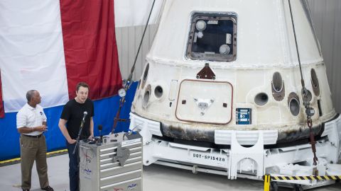 NASA'S Charles Bolden, left, and SpaceX CEO Elon Musk stand next to the Dragon capsule in June in McGregor, Texas.