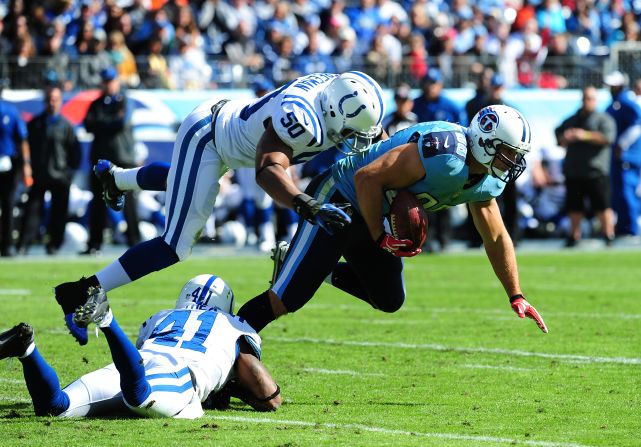 No. 88 Craig Stevens of the Tennessee Titans is tackled by No. 50 Jerrell Freeman and No. 41 Antoine Bethea of the Indianapolis Colts at LP Field on Monday in Nashville, Tennessee.