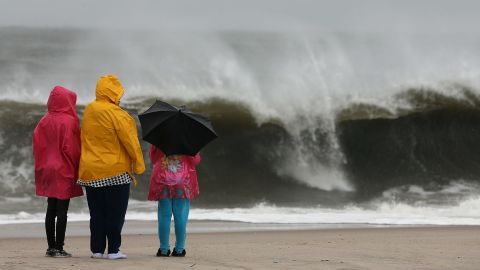 People watch the heavy surf caused by approaching Hurricane Sandy on October 28, 2012, in Cape May, New Jersey.