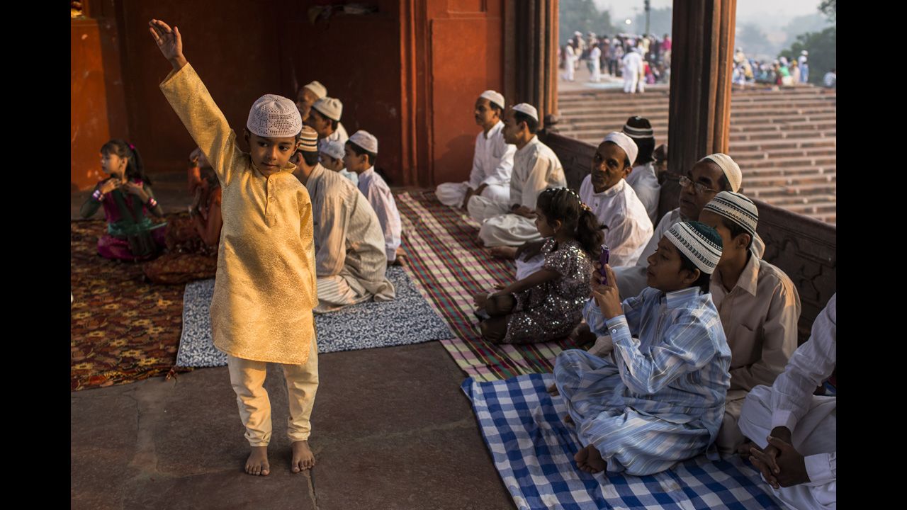 A boy poses for a photograph as Indian Muslims gather for Eid al-Adha prayers at the Jama Masjid mosque in New Delhi on Saturday.