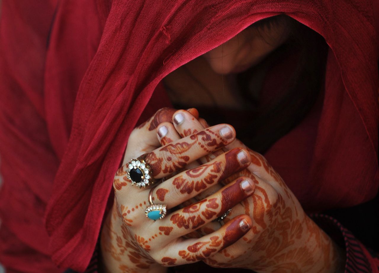 A woman prays during Eid prayers at the Badshahi Mosque in Lahore, Pakistan, on Saturday, October 27. Eid al-Adha, or the Feast of Sacrifice, marks the end of the annual Hajj pilgrimage to Mecca, Saudi Arabia, and honors the Prophet Ibrahim's willingness to sacrifice his son, Ishmael, on the order of God, who according to the religion then provided a lamb in the boy's place. More than 2 million Muslims make the annual Hajj pilgrimage to Mecca, which is one of the five pillars of Islam.