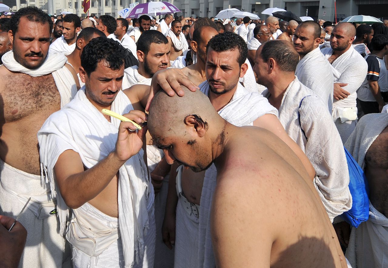 A man shaves the head of a Muslim pilgrim after the Jamarat ritual in Mina.