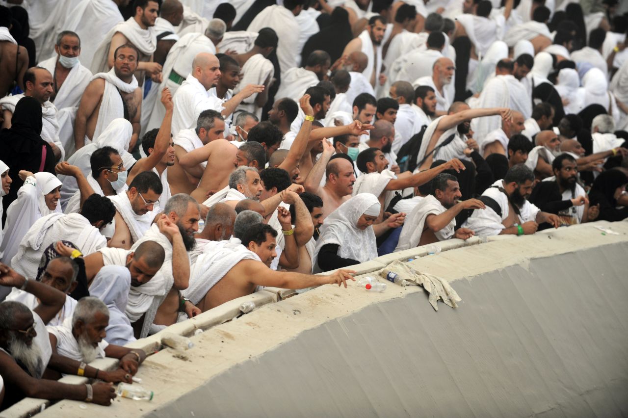 Muslim pilgrims throw pebbles at pillars during the Jamarat ritual in Mina near the holy city of Mecca, Saudi Arabia, on Friday. During the stoning of Satan ritual, pilgrims pelt pillars symbolizing the devil with stones to show their defiance.