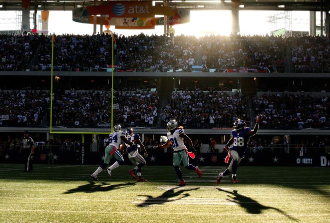 Mike Jenkins of the Cowboys covers Hakeem Nicks of the Giants on a pass play.