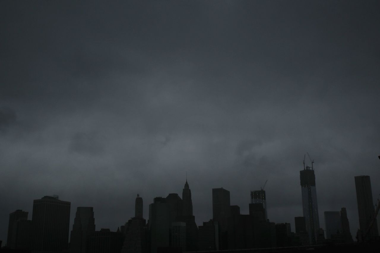 Dark clouds cover the skyline of Manhattan early Monday.
