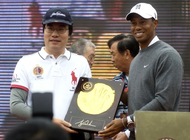 Both McIlroy and Woods, pictured above, had their handprints immortalized in clay as a lavish ceremony featuring drum majorettes and fireworks preceded their clash in the Chinese city Zhengzhou. 