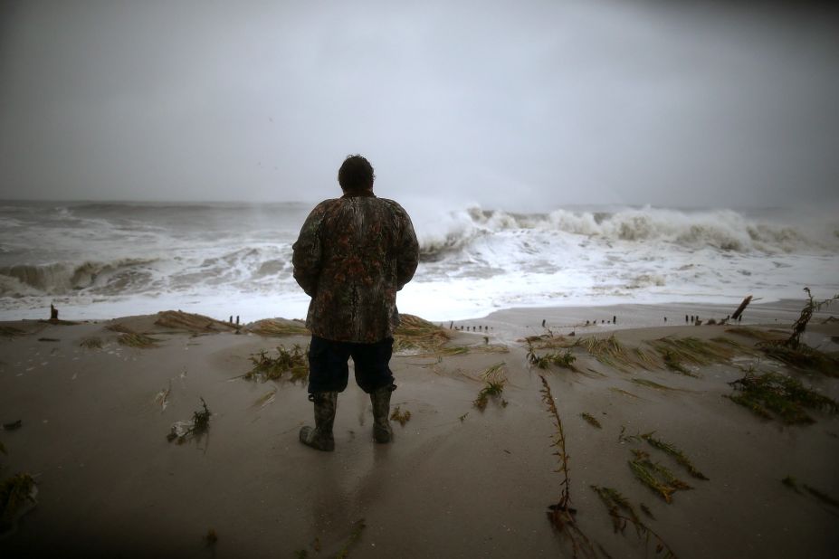 Andy Becica watches the heavy surf from Hurricane Sandy wash in Monday at Cape May, New Jersey. The full force of Hurricane Sandy is expected to hit the New Jersey coastline later Monday.
