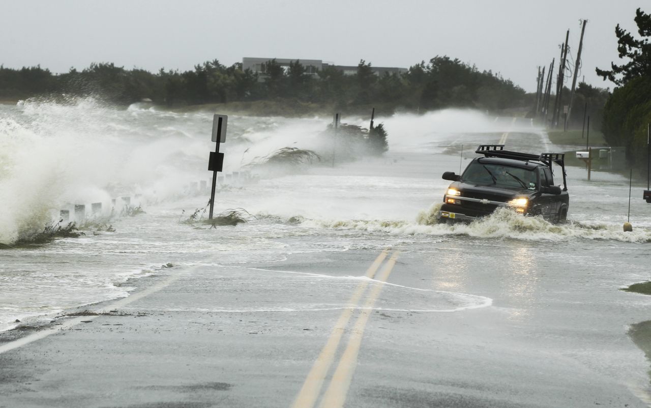 A truck fights its way through water on a road in Southampton, New York, on Monday.