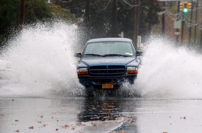 A truck moves north on South Long Beach Avenue as rising water and wind ahead of Hurricane Sandy flood the area on Monday in Freeport, New York. The storm, which threatens 50 million people in the eastern third of the United States, is expected to bring days of rain, high wind and, in places, heavy snow.