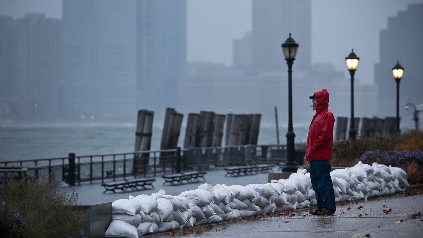 A man watches the waves in New York Harbor from Battery Park during the arrival of Hurricane Sandy on October 29, 2012 in New York City. The core of Sandy's force is supposed to hit the New York area Monday night. 
