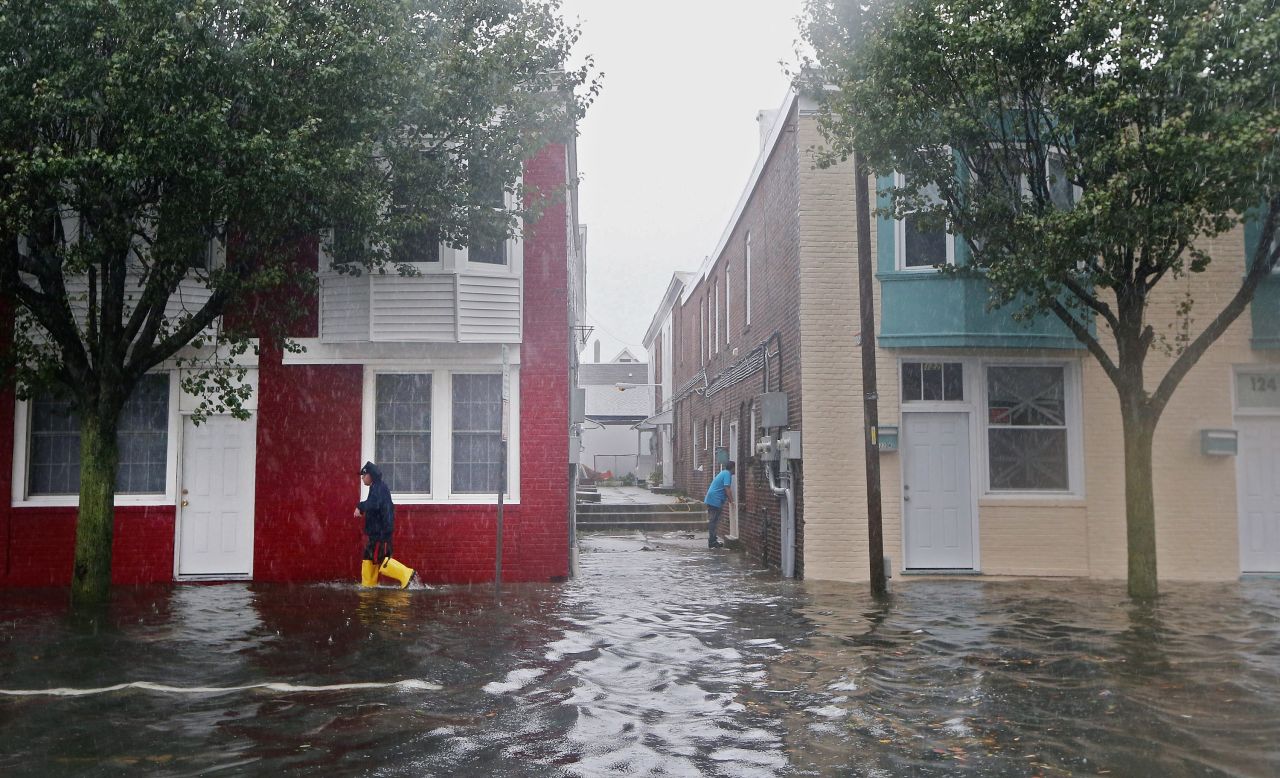 A man walks down a flooded street in Atlantic City  on Monday before the hurricane makes landfall.