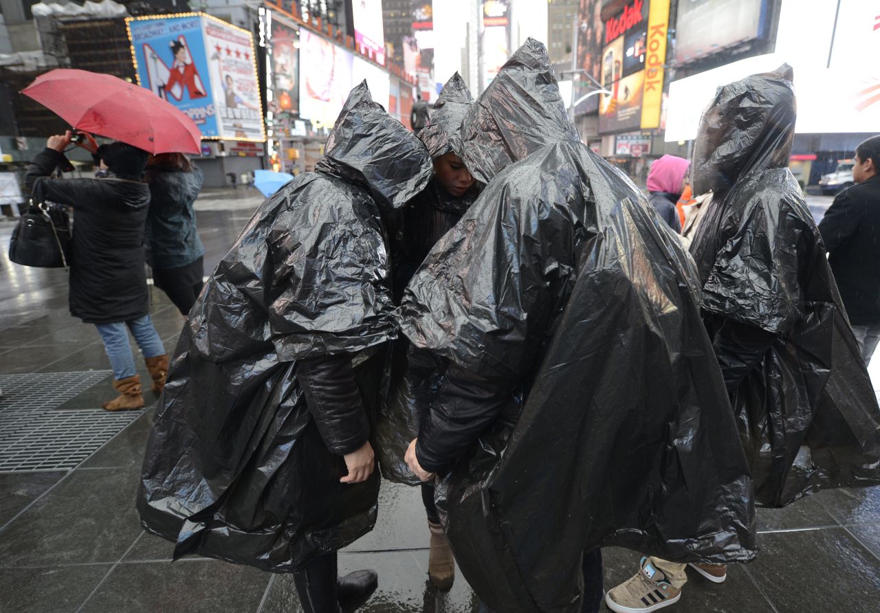 Tourists wear plastic ponchos in Times Square on Monday. 