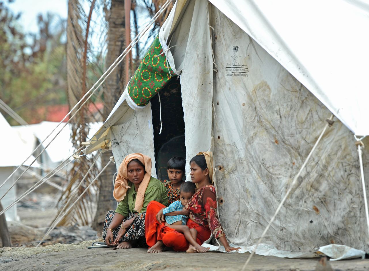 A  Muslim Rohingya family sits outside a tent on Sunday. The U.N. says the displaced are in urgent need of assistance. 