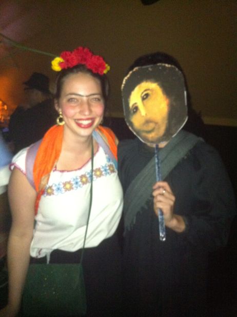 <a href="http://ireport.cnn.com/docs/DOC-865461">Alice Feigel</a>, dressed as Frida Kahlo on the left, is standing next to Internet meme <a href="http://knowyourmeme.com/memes/events/botched-ecce-homo-painting" target="_blank" target="_blank">Botched Ecce Homo Painting</a>. The meme when viral online after the <a href="http://news.blogs.cnn.com/2012/08/23/church-masterpiece-restored-as-mr-bean-would-do-it/">failed restoration</a> of a century-old fresco of Jesus Christ. 