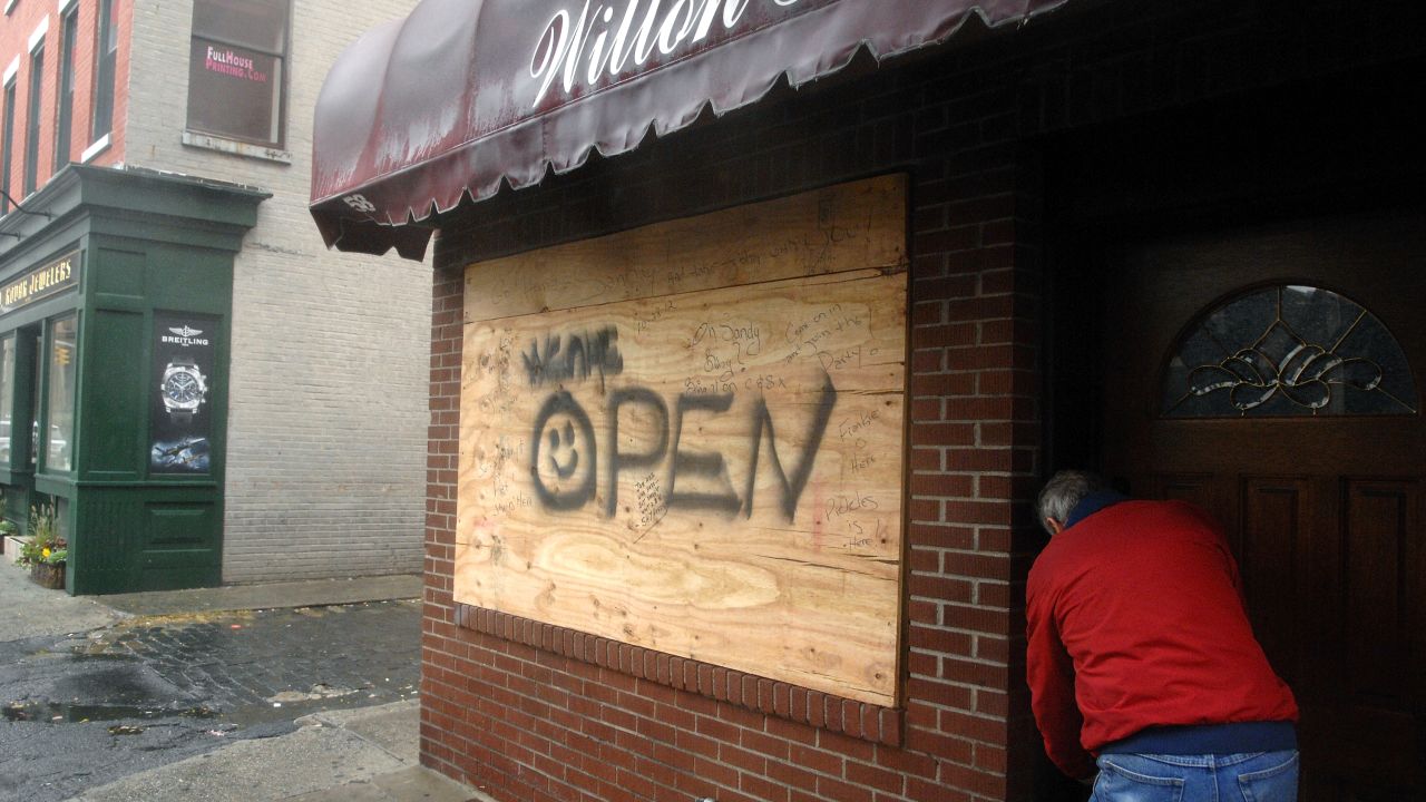 The owner of the Wilton House locks up his bar on Monday in Hoboken, New Jersey, as Hurricane Sandy approaches the area.