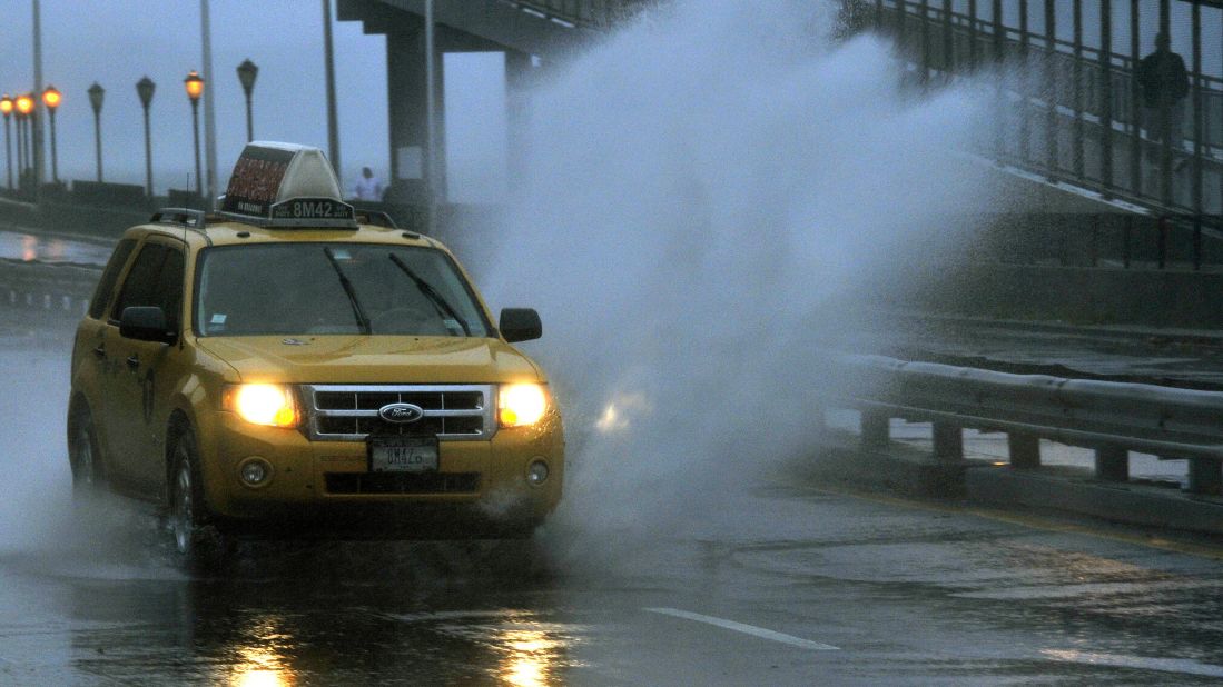 A car goes through standing water along FDR Drive as New Yorkers venture out into the stormy conditions on Monday, October 29.