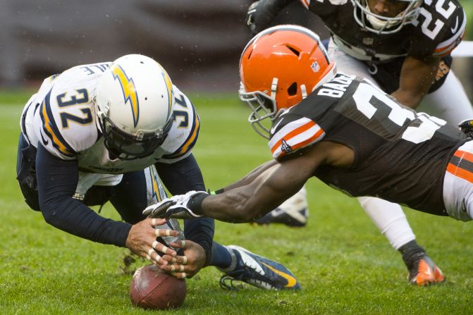 Free safety Eric Weddle of the Chargers jumps on a loose ball as cornerback Johnson Bademosi of the Browns reaches for it during the second half on Sunday.
