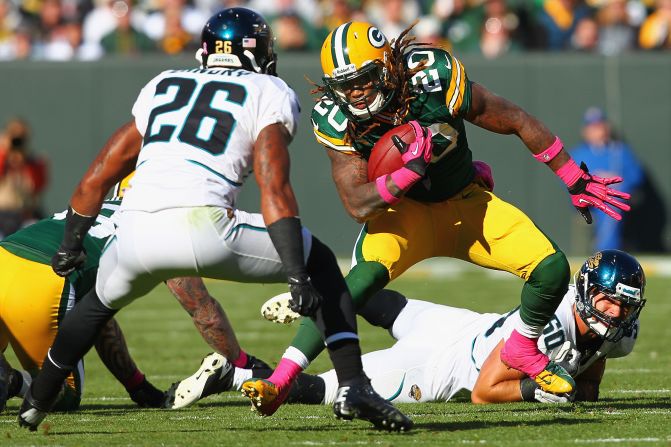 Packers No. 20 Alex Green tries to avoid being tackled by Jaguars players on Sunday.