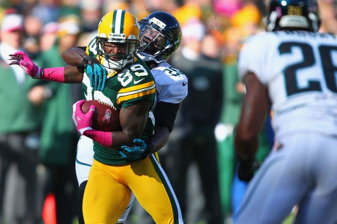 Jacksonville's Mike Harris tackles Green Bay's James Jones on Sunday.