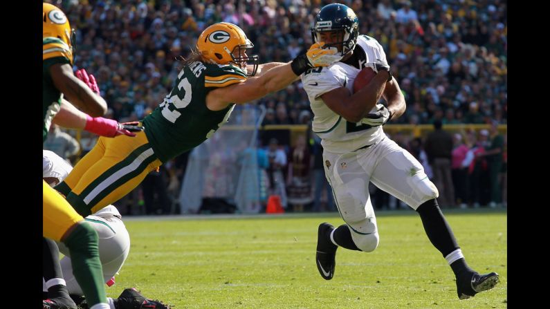 Dwight Lowery of the Jacksonville Jaguars is tackled by Clay Matthews of the Green Bay Packers at Lambeau Field in Green Bay, Wisconsin, on Sunday.
