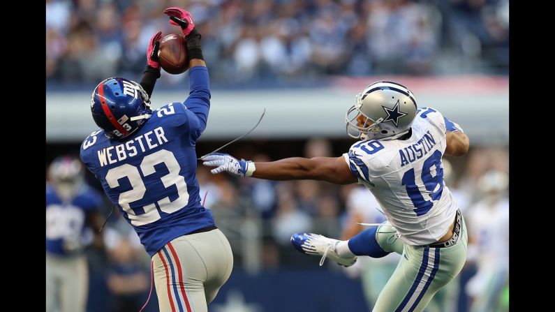 Corey Webster of the New York Giants intercepts a pass intended for Miles Austin of the Dallas Cowboys in Arlington, Texas, on Sunday.
