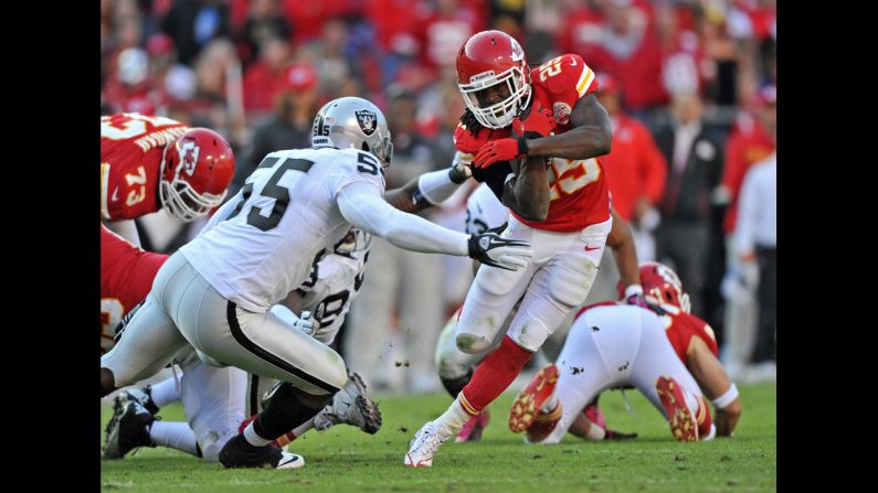 Chiefs running back Jamaal Charles rushes around Raiders linebacker Rolando McClain during the third quarter.