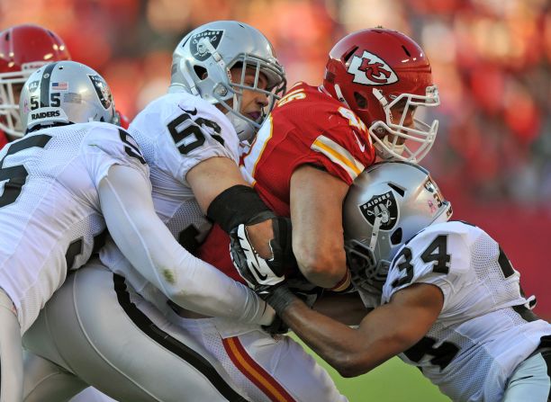 Oakland Raiders defenders No. 55 Rolando McClain, No. 56 Miles Burris and No. 34 Mike Mitchell tackle running back Peyton Hillis of the Kansas City Chiefs during the second quarter on Sunday in Kansas City, Missouri. The Raiders defeated the Chiefs 26-16.