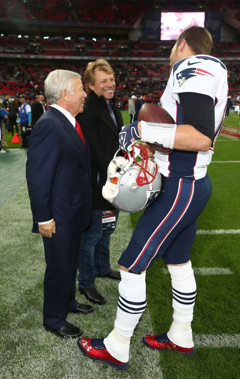 The quarterback towers over Patriots owner Robert Kraft and rock star Jon Bon Jovi, who was one of the celebrity guests. 