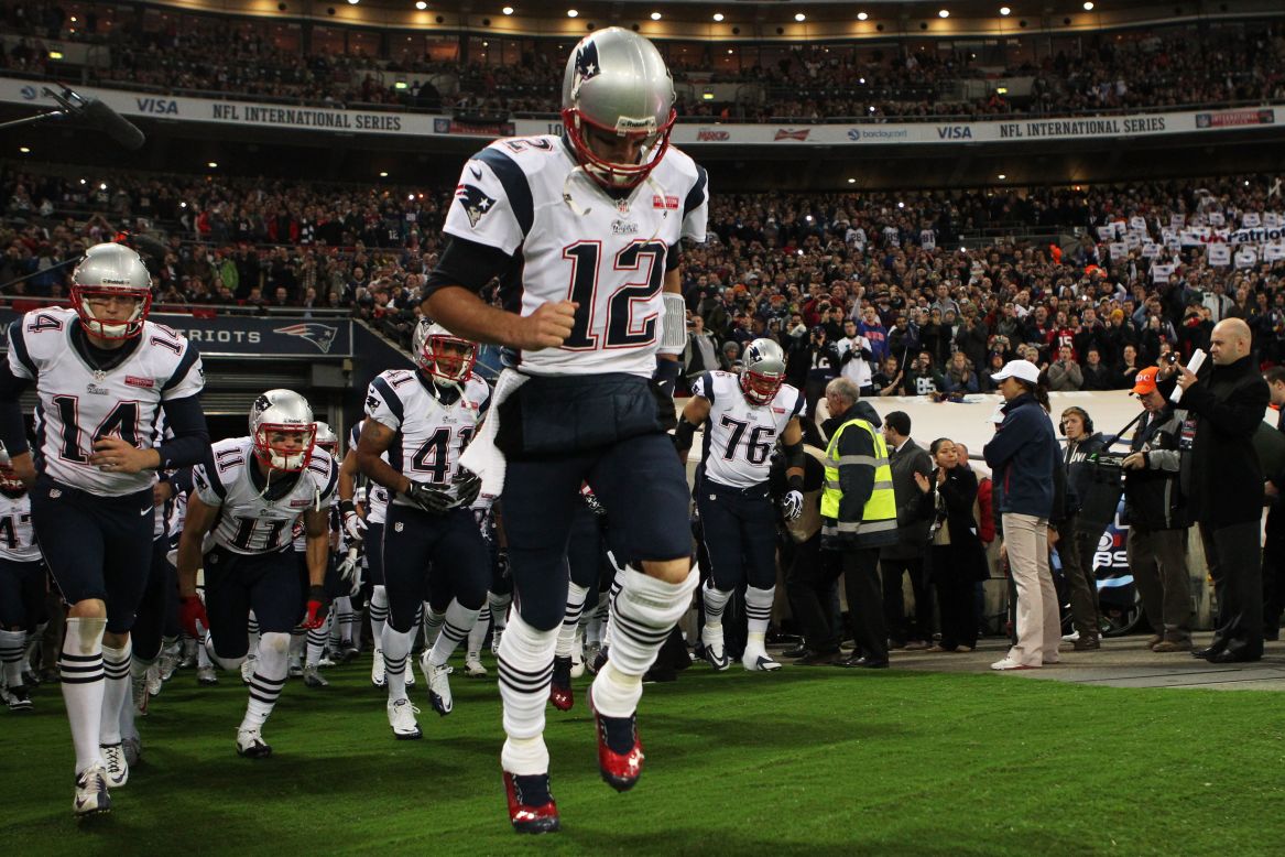 Tom Brady leads the New England Patriots onto the field for the match against the St. Louis Rams.