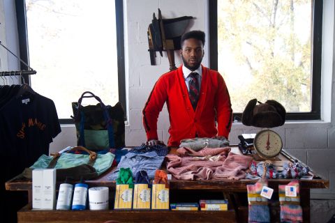 Najee Redd, store manager of <a href="http://www.sirandmadame.com/" target="_blank" target="_blank">Sir & Madame</a> in Chicago, displays American-made clothing and accessories available at the store.
