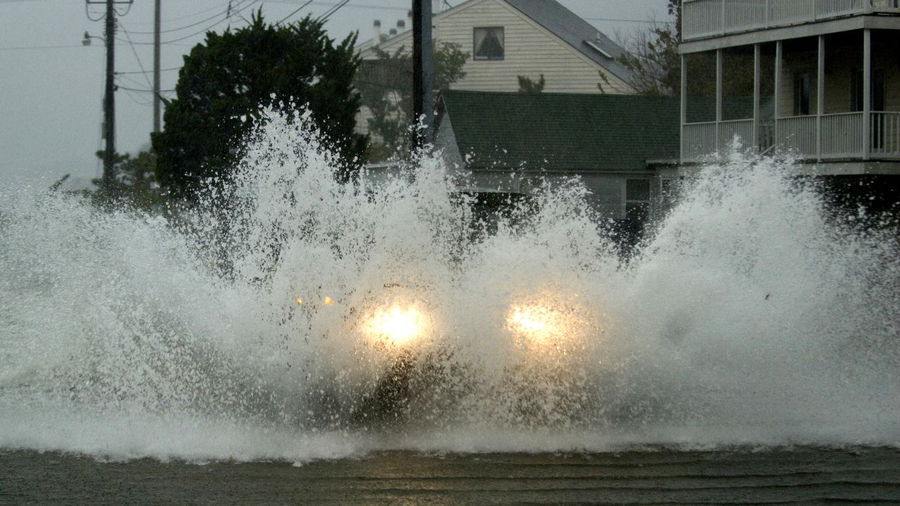 An emergency vehicle plows through floodwaters on Monday in Dewey Beach, Delaware.