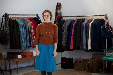 Penelope's co-owner, Jena Frey, stands among the store's collection of American-made clothing at NorthernGRADE.