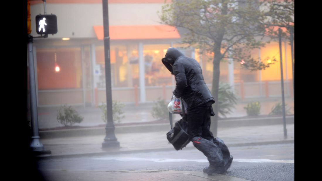 A person tries to cross the street during the storm on Monday in Atlantic City.