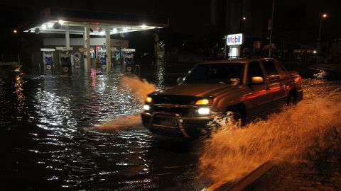 A truck drives by a flooded gas station in the Gowanus section of Brooklyn on Monday.