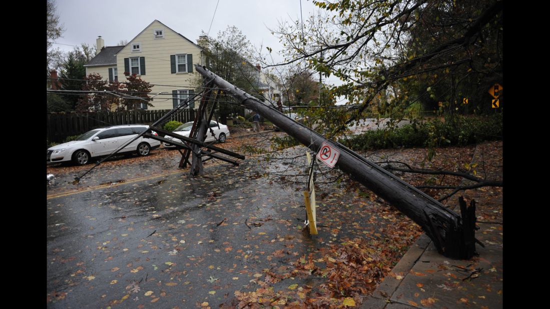 A power line knocked over by a falling tree blocks a street in Chevy Chase, Maryland, on Tuesday.