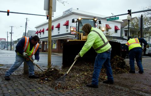 Workers shovel debris from the streets in Ocean City, Maryland, on Tuesday.