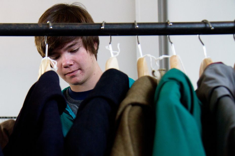 Nick Rokosz, 16, looks through vintage coats and jackets for sale from MidNorth Mercantile at NorthernGRADE pop-up menswear market in Chicago on Saturday, October 27. 