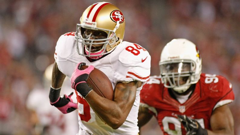 Randy Moss of the San Francisco 49ers sprints to the end zone in front of Sam Acho of the Arizona Cardinals on a touchdown catch during the third quarter on Monday, October 29, at the University of Phoenix Stadium in Glendale, Arizona. Check out the action from Week 8 of the NFL, or <a href="index.php?page=&url=http%3A%2F%2Fwww.cnn.com%2F2012%2F10%2F18%2Fworldsport%2Fgallery%2Fnfl-week-7%2Findex.html">look back at the best from Week 7</a>.