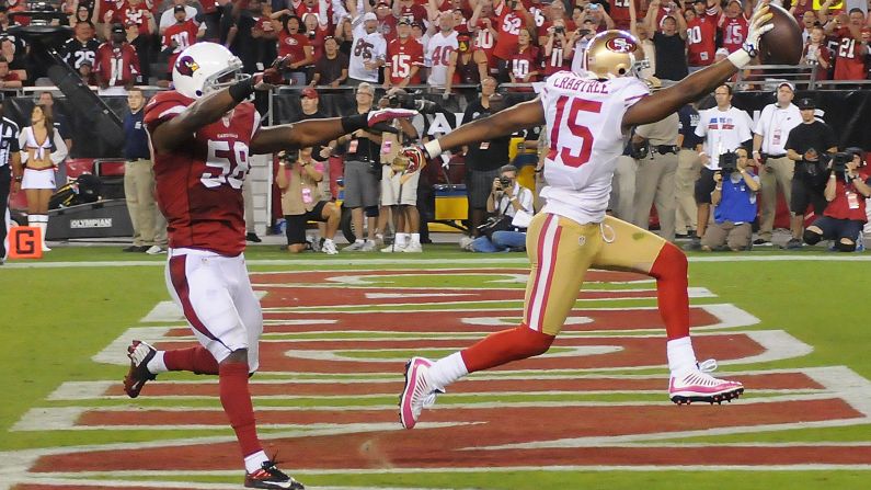 Michael Crabtree of the San Francisco 49ers scores a touchdown in front of Daryl Washington of the Arizona Cardinals on Monday.