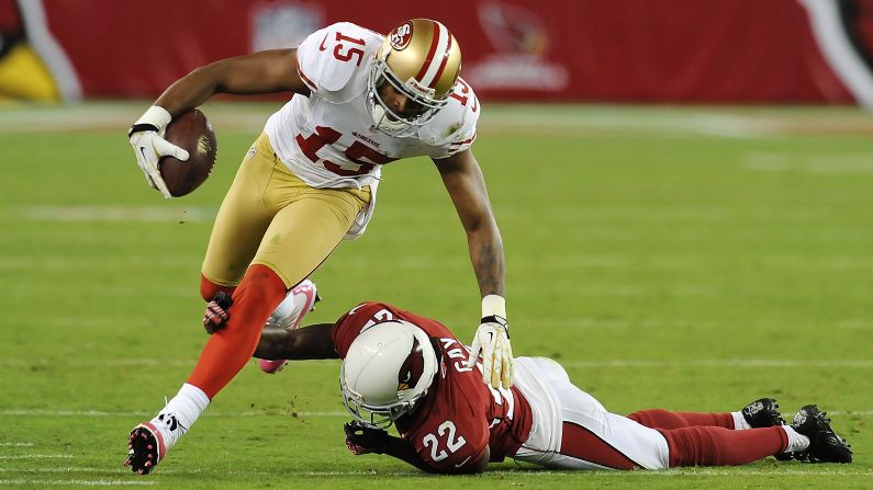 Michael Crabtree of the 49ers runs with the ball as William Gay of the Cardinals attempts to make a tackle.