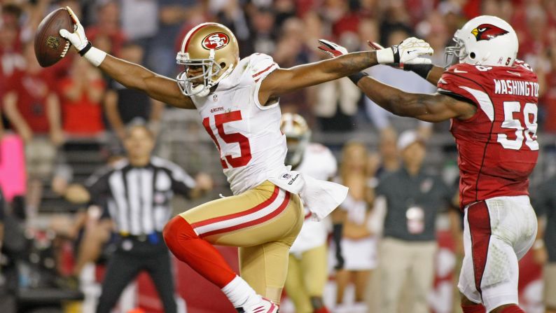 Michael Crabtree of the 49ers celebrates as he beats Daryl Washington of the Cardinals into the end zone for a touchdown Monday night.